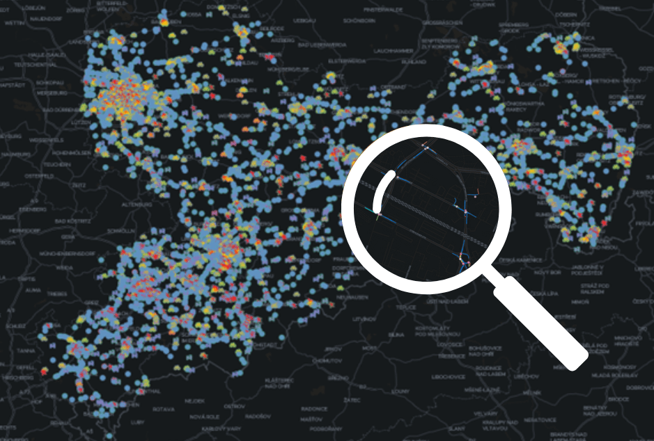 Map with colour-coded dots representing traffic or accident clusters, with a large magnifying glass in the foreground that enlarges part of the map.