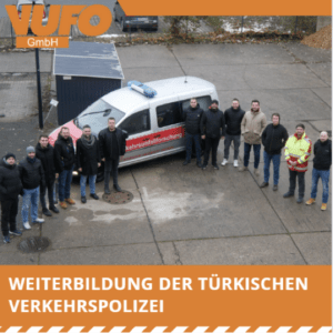 Group photo of participants in a training course organised by the Turkish traffic police, taken in front of a traffic accident research vehicle. The VuFo GmbH logo is visible in the background.